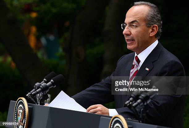Mexican President Felipe Calderon answers a question during a joint press conference with U.S. President Barack Obama in the Rose Garden of the White...