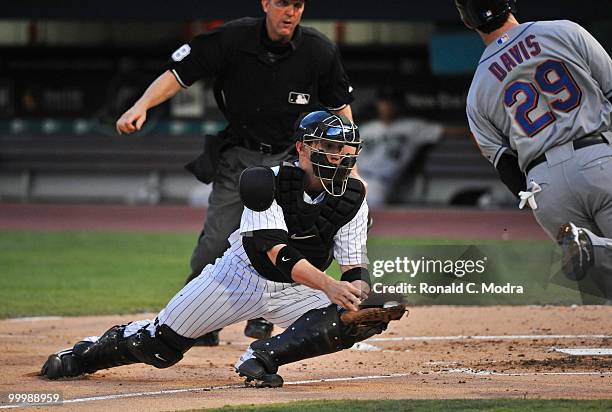 Brett Hayes of the Florida Marlins takes the throw at home as Ike Davis of the New York Mets tries to score during a MLB game in Sun Life Stadium on...