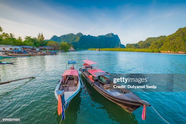 long tail boat at tropical beach in south thailand. - koh poda stock pictures, royalty-free photos & images