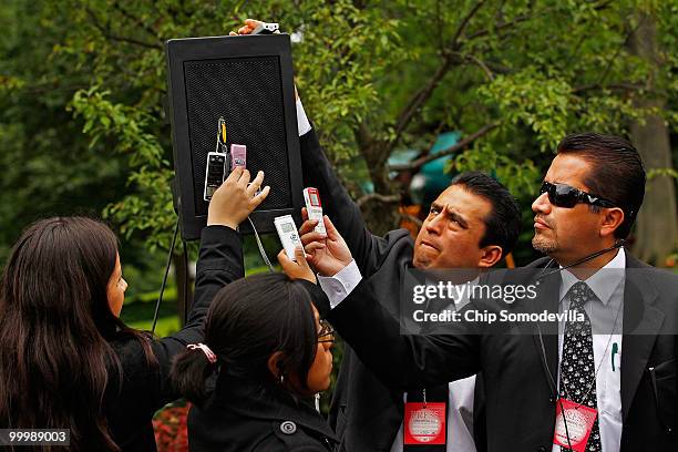 Members of the Mexican press hold audio recording devices against a speaker during a news conference with U.S. President Barack Obama and Mexican...