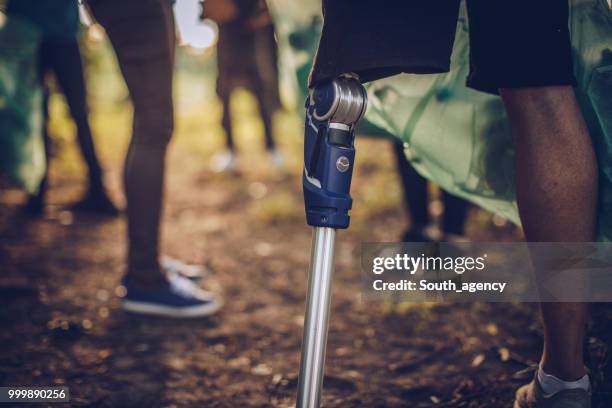 volunteers collecting rubbish in park - south_agency stock pictures, royalty-free photos & images