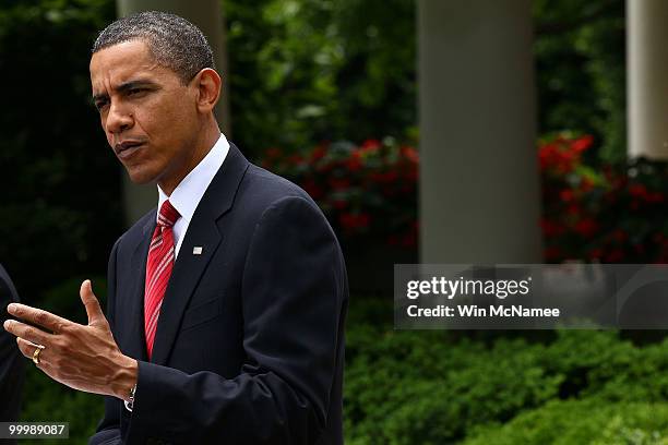 President Barack Obama answers a question during a joint press conference with Mexican President Felipe Calderon in the Rose Garden of the White...