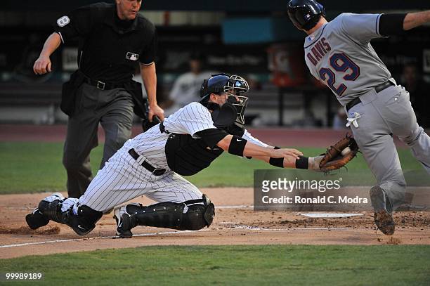 Brett Hayes of the Florida Marlins tags out Ike Davis of the New York Mets at home during a MLB game in Sun Life Stadium on May 15, 2010 in Miami,...