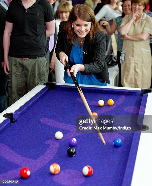 Princess Eugenie of York plays pool as she attends the opening of the Teenage Cancer Trust Unit at the Great North Children's Hospital on May 19,...