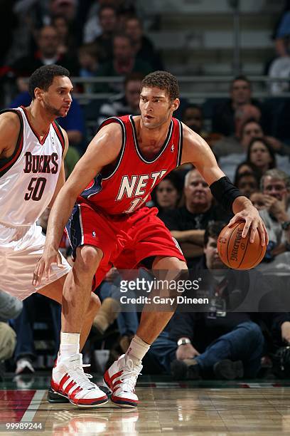 Brook Lopez of the New Jersey Nets drives the ball against Dan Gadzuric of the Milwaukee Bucks during the game at the Bradley Center on April 7, 2010...
