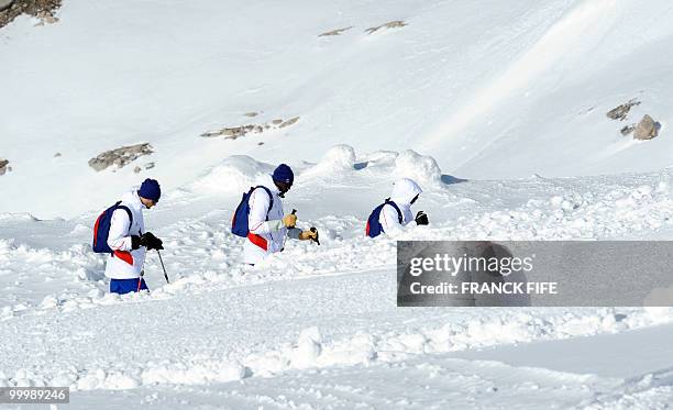 French national football team's goalkeeper Hugo Lloris and midfielder Alou Diarra walk with snowshoes at the top of the Tignes glacier on May 19,...