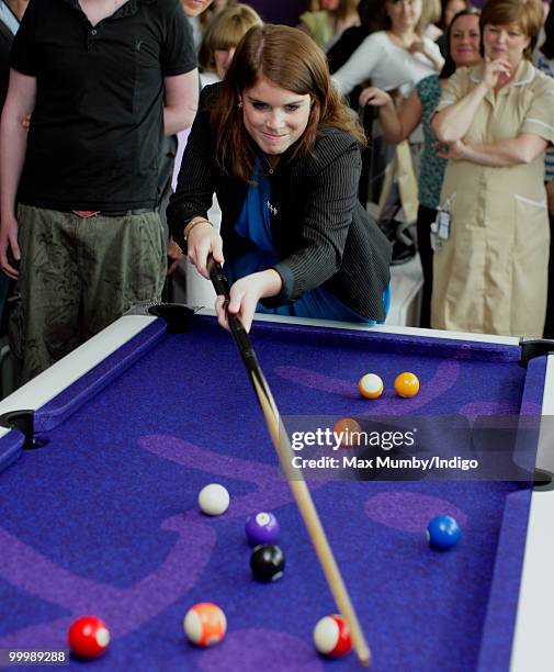 Princess Eugenie of York plays pool as she attends the opening of the Teenage Cancer Trust Unit at the Great North Children's Hospital on May 19,...