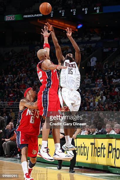 John Salmons of the Milwaukee Bucks puts a shot up against Jarvis Hayes OF the New Jersey Nets during the game at the Bradley Center on April 7, 2010...