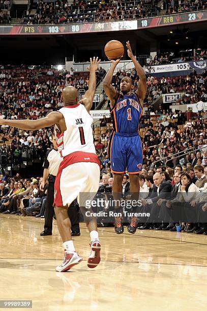Chris Duhon of the New York Knicks shoots a jump shot against Jarrett Jack of the Toronto Raptors during the game at Air Canada Centre on April 14,...