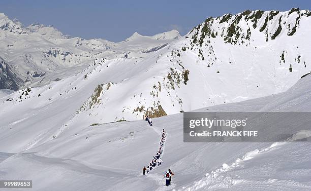 French national football team'splayers walk with snowshoes at the top of the Tignes glacier on May 19, 2010 in the French Alps. The French national...