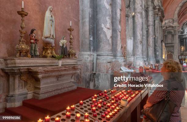 Faithful prays before a figure of Our Lady of Fatima in Sao Domingos church on July 13, 2018 in Lisbon, Portugal. Sao Domingos was dedicated in 1241...