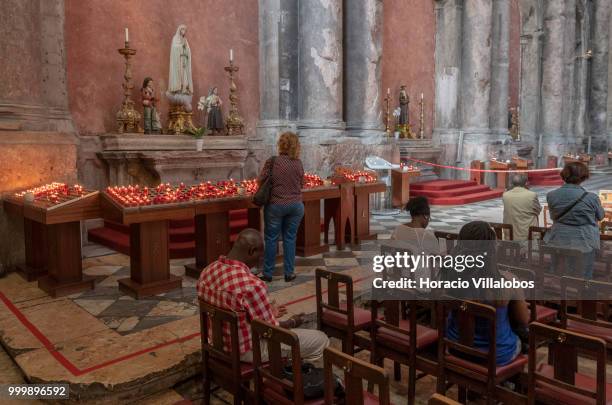 Faithful pray near a figure of Our Lady of Fatima in Sao Domingos church on July 13, 2018 in Lisbon, Portugal. Sao Domingos was dedicated in 1241 and...