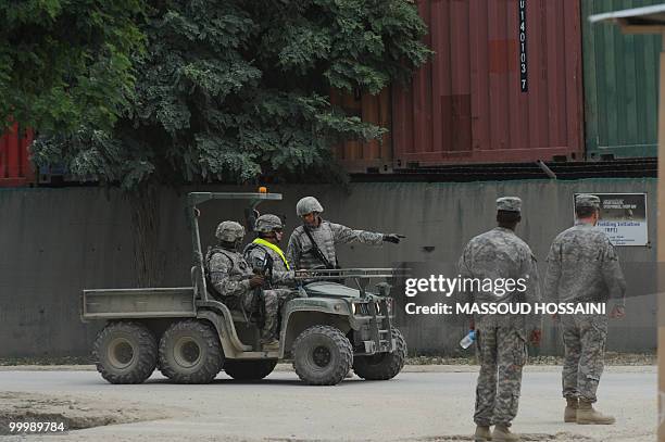Army soldiers are pictured at a roadblock after they closed the main road after a Taliban attack on US air base in Bagram, 50 kms north of Kabul, on...