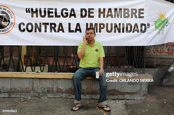 Honduran judge Adan Guillermo Lopez, member of the Movimiento Amplio por la Dignidad y la Justica speaks on his mobile phone during the thirth day of...