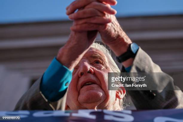 Labour politician and Member of Parliament for Bolsover Dennis Skinner on the balcony of the County Hotel watches colliery bands pass below during...