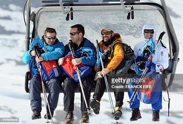 France's football team's coach Raymond Domenech sits in a ski lift upon his arrival at the top of the Tignes glacier on May 19, 2010 in the French...