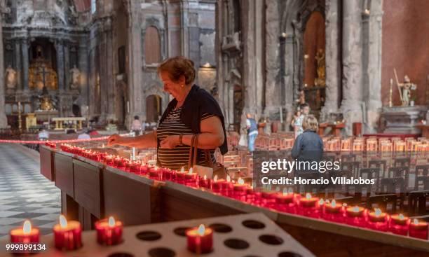 Faithful lights candles in front a figure of Our Lady of Fatima in Sao Domingos church on July 13, 2018 in Lisbon, Portugal. Sao Domingos was...