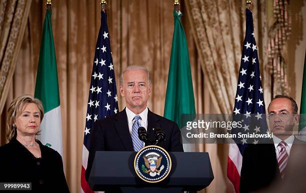 Secretary of State Hillary Rodham Clinton and Mexico's President Felipe Caldero listen while Vice President Joseph R. Biden pauses while giving a...