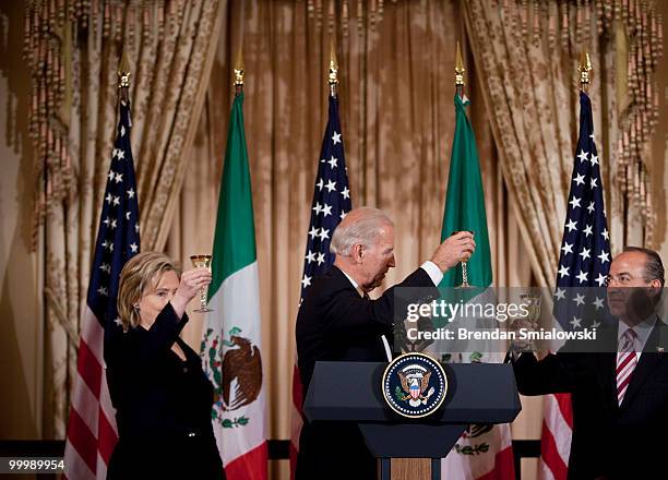 Secretary of State Hillary Rodham Clinton , Vice President Joseph R. Biden and Mexico's President Felipe Caldero toast during a luncheon at the US...