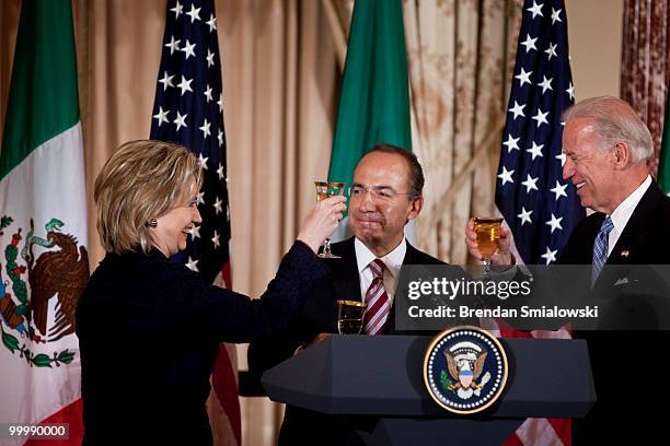 Secretary of State Hillary Rodham Clinton , Vice President Joseph R. Biden and Mexico's President Felipe Caldero toast during a luncheon at the US...