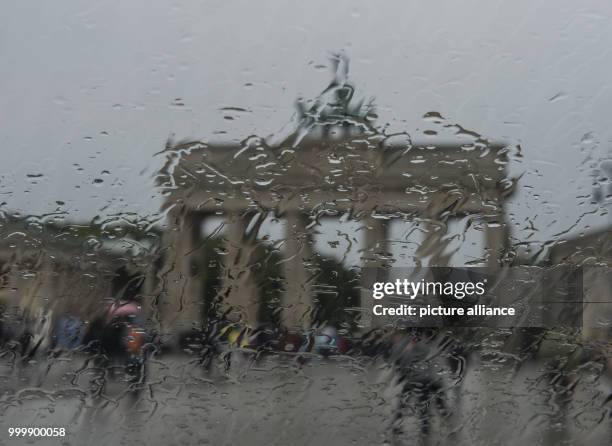 View of the Brandenburg Gate through a window in the rain in Berlin, Germany, 9 September 2017. Photo: Paul Zinken/dpa