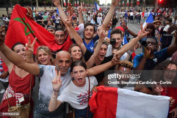 Fans celebrate the Victory of France in the World Cup 2018, on the Champs Elysees on July 15, 2018 in Paris, France.