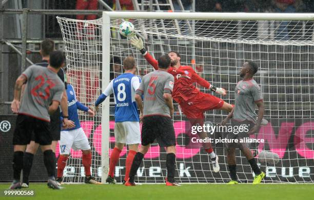 Kiel's goalkeeper Kenneth Kronholm blocks an attempt on goal by Kaiserlautern's Osayamen Osawe during the German 2nd Bundesliga soccer match between...