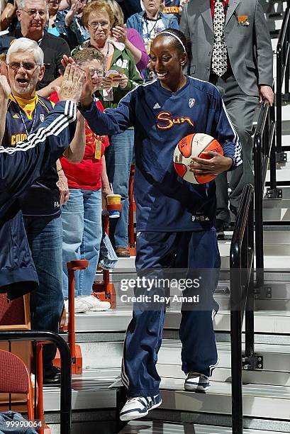 Allison Hightower of the Connecticut Sun high fives a teammate as she carries an autographed team ball down stairs to the court before the game...