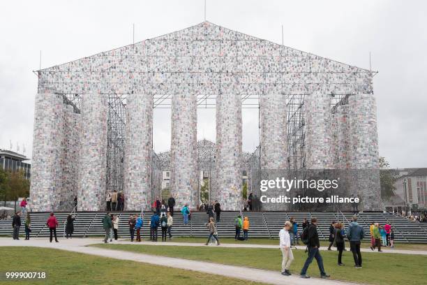 Visitors stand in front of Argentinian artist Marta Minujin's work 'The Parthenon of Books' at the documenta art festival in Kassel, Germany, 9...