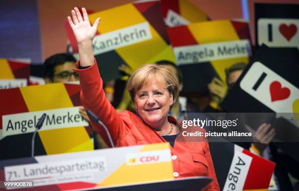 Angela Merkel, the head of the CDU and the German chacellor, waves to supporters after giving a speech during a local party convention of CDU in...