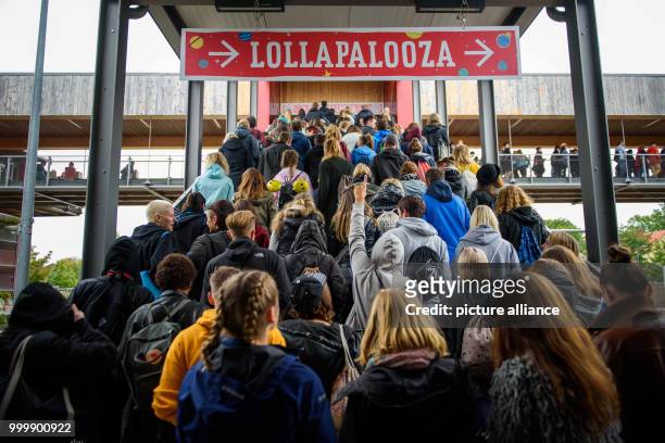 Revellers arrive at the Lollapalooza festival in Hoppegarten, Germany, 9 September 2017. The music festival is held over two days on the 9 and 10...
