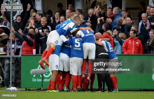 Kiel's Manuel Janzer celebrates with teammates after giving his side a 2:1 lead during the German 2nd Bundesliga soccer match between Holstein Kiel...