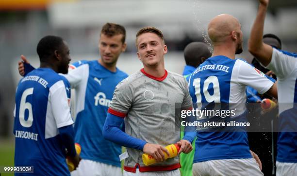 Kiel's Manuel Janzer celebrates with his teammates at the end of the German 2nd Bundesliga soccer match between Holstein Kiel and 1. FC...