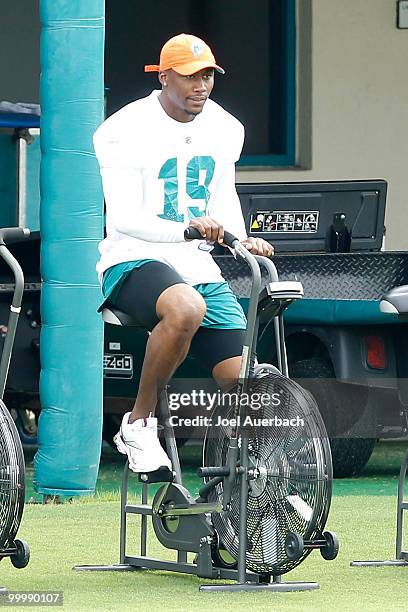 Brandon Marshall of the Miami Dolphins rides the stationary bike during the organized team activities on May 19, 2010 at the Miami Dolphins training...