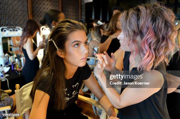 Model prepares backstage for Fashion Palette Miami Australian Swim Show SS19 at The Setai Miami Beach on July 15, 2018 in Miami Beach, Florida.