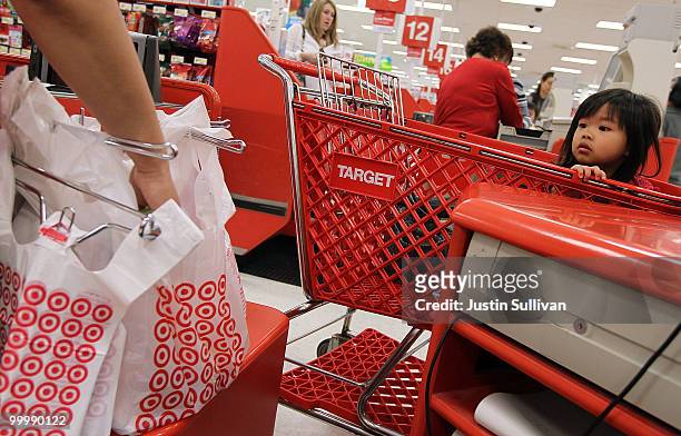 Young girl watches as a cashiers bags groceries at a Target store May 19, 2010 in Daly City, California. Target reported first quarter earnings up 29...