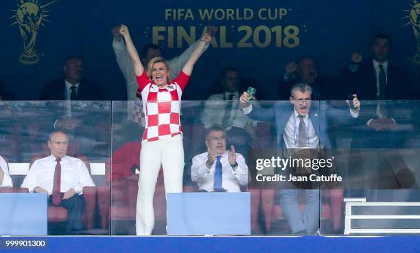 President of Croatia Kolinda Grabar-Kitarovic celebrates the first goal for Croatia with President of Croatian Football Federation Davor Suker while...