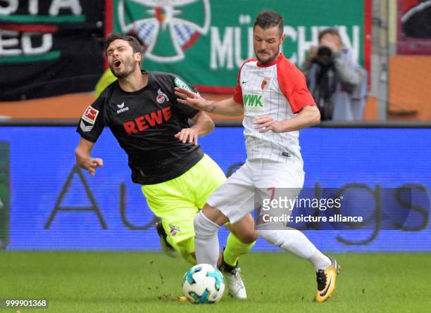 Augsburg's Marcel Heller and Cologne's Jonas Hector vie for the ball during the German Bundesliga soccer match between FC Augsburg and 1. FC Cologne...