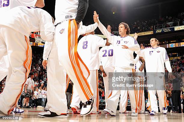 Steve Nash of the Phoenix Suns high fives his teammates before the game against the New Orleans Hornets on March 14, 2010 at US Airways Center in...