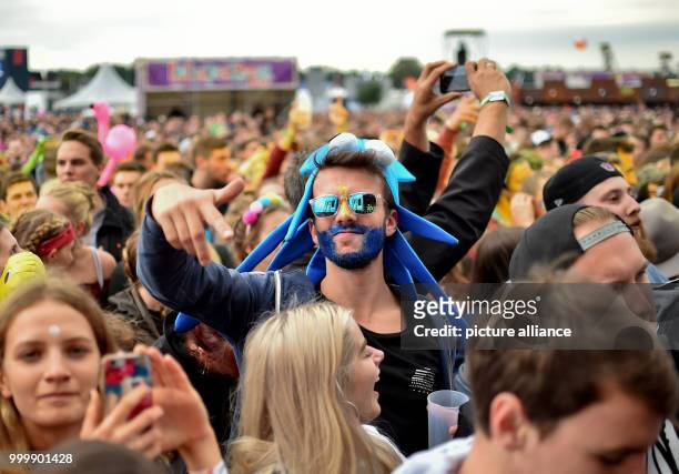 Revellers dance at the Lollapalooza festival in Hoppegarten, Germany, 9 September 2017. The music festival is held over two days on the 9 and 10...