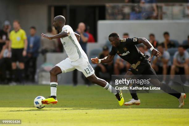 Lawrence Olum of the Portland Timbers moves the ball against Adama Diomande of the Los Angeles Football Club at Banc of California Stadium on July...