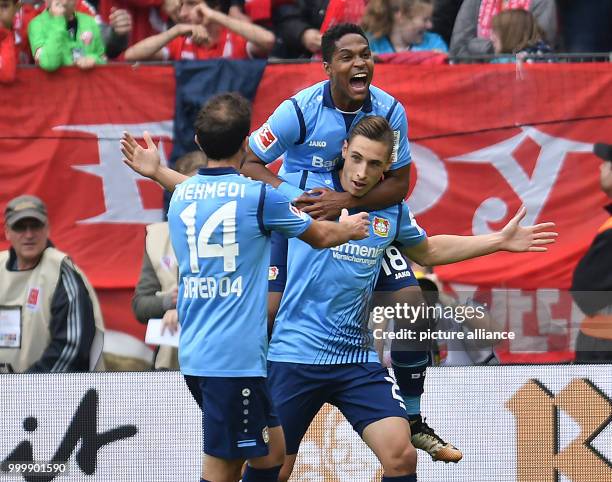 Leverkusen's Dominik Kohr celebrates his 0:1 goal with Admir Mehmedi and Wendell during the Bundesliga soccer match between FSV Mainz 05 and Bayer...