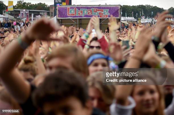Revellers dance in front of the stage at the Lollapalooza festival in Hoppegarten, Germany, 9 September 2017. The music festival is held over two...