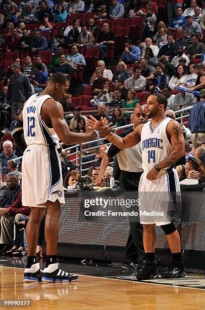 Dwight Howard and Jameer Nelson of the Orlando Magic high five during the game against the Los Angeles Clippers on March 9, 2010 at Amway Arena in...