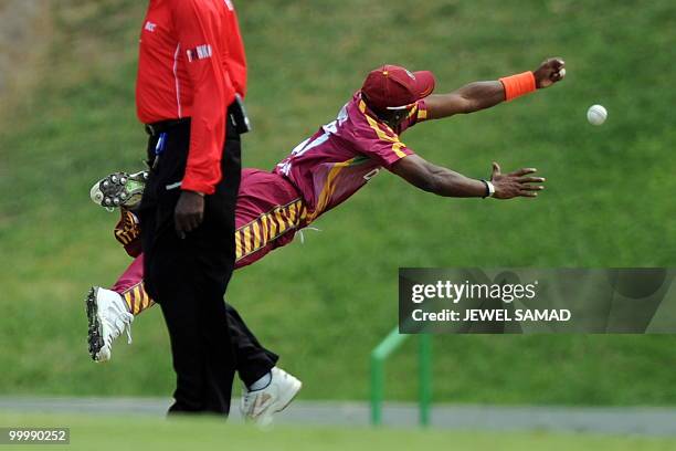 West Indies cricketer Dwayne Bravo unsuccessfully dives to catch the ball hit by South African cricket team captain Graeme Smith during the first T20...