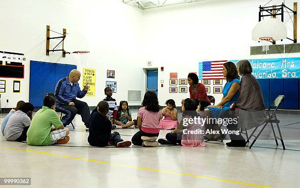 First lady Michelle Obama and her Mexican counterpart Margarita Zavala listen to PE teacher Thomas Ryan during a physical education class as they...