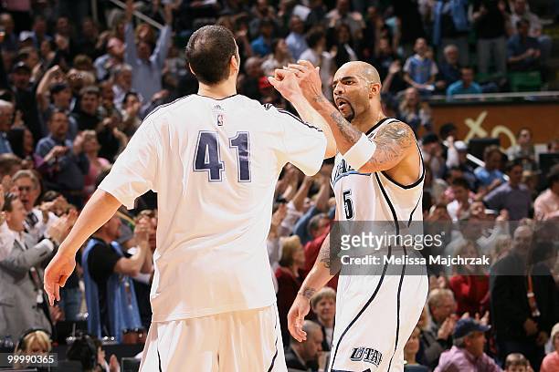 Kosta Koufos and Carlos Boozer of the Utah Jazz high five during the game against the Boston Celtics at EnergySolutions Arena on March 22, 2010 in...