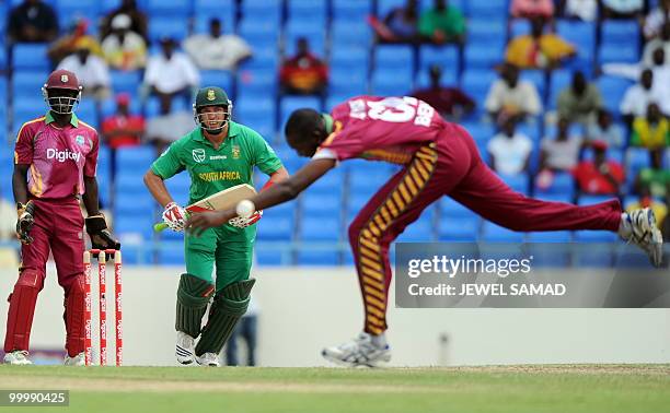 South African cricketer Jacques Kallis hits the ball as West Indies bowler Sulieman Benn stretches to field during the first T20 match between West...