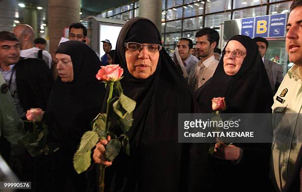 Laura Fattal , Nora Shourd and Cindy Hickey , mothers of US hikers detained in Iran, hold roses upon their arrival at the Imam Khomeini airport in...