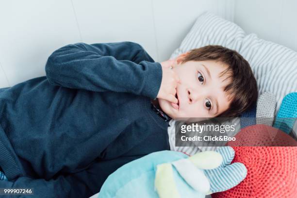 cute little boy playing indoors (on a bed) - click&boo stock pictures, royalty-free photos & images